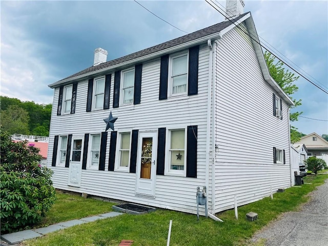 353 S Washington St, Waynsbrg/Frankln Twp, PA 15370 - view of home's exterior featuring a chimney and a lawn