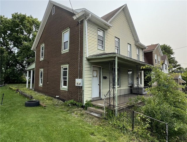 428 2nd St, Donora, PA 15033 - view of front of house featuring covered porch, a front lawn, and brick siding