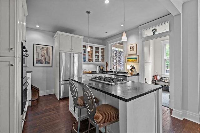 618 Hastings St, Point Breeze, PA 15206 - kitchen featuring stainless steel appliances, dark countertops, baseboards, white cabinets, and dark wood-style floors