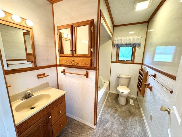 152 Aviator Ln, Somerset Twp, PA 15541 - full bath with tile walls, toilet, vanity, a textured ceiling, and ornamental molding