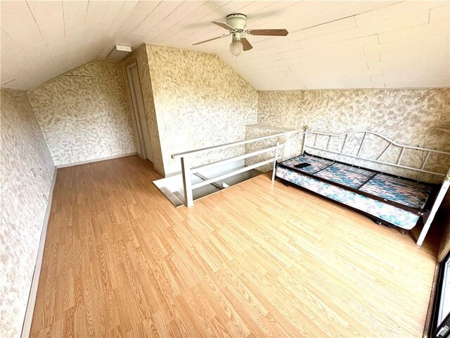 152 Aviator Ln, Somerset Twp, PA 15541 - bonus room featuring vaulted ceiling, light wood-style flooring, ceiling fan, and wallpapered walls