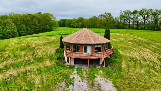 152 Aviator Ln, Somerset Twp, PA 15541 - rear view of property featuring driveway, a lawn, a wooden deck, and a forest view