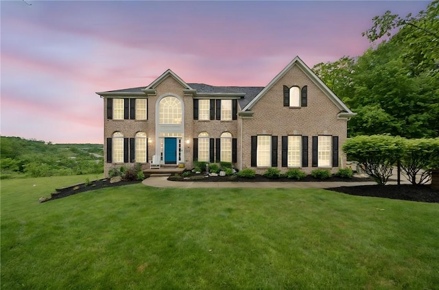 8426 David Dr, South Fayette, PA 15017 - view of front facade with brick siding and a yard