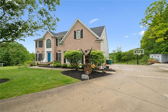8426 David Dr, South Fayette, PA 15017 - view of front of house with brick siding, a front lawn, and concrete driveway