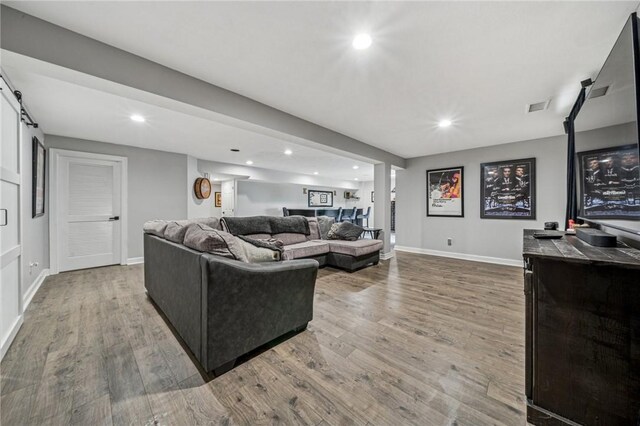 8426 David Dr, South Fayette, PA 15017 - living area featuring wood finished floors, baseboards, recessed lighting, and a barn door