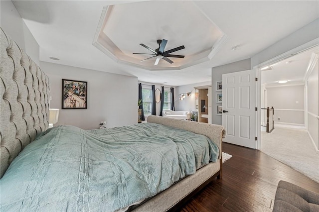 8426 David Dr, South Fayette, PA 15017 - bedroom featuring dark wood-style floors, a tray ceiling, and a ceiling fan
