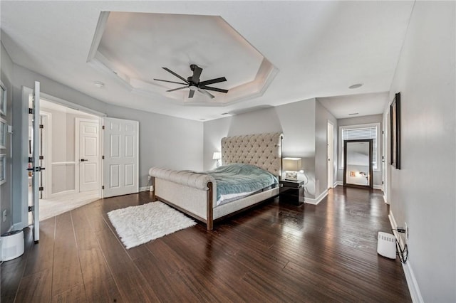 8426 David Dr, South Fayette, PA 15017 - bedroom with a tray ceiling, dark wood-type flooring, baseboards, and ceiling fan