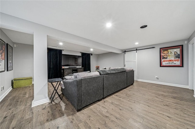 8426 David Dr, South Fayette, PA 15017 - living area with a barn door, wood finished floors, recessed lighting, and baseboards