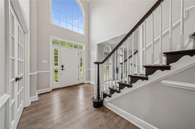 8426 David Dr, South Fayette, PA 15017 - entryway with stairway, a high ceiling, wood-type flooring, and baseboards