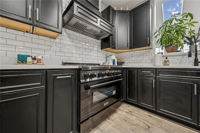 8426 David Dr, South Fayette, PA 15017 - kitchen featuring range with gas stovetop, custom exhaust hood, and dark cabinetry