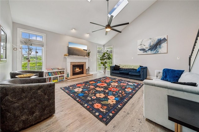 8426 David Dr, South Fayette, PA 15017 - living room with a fireplace, healthy amount of natural light, ceiling fan, wood finished floors, and high vaulted ceiling