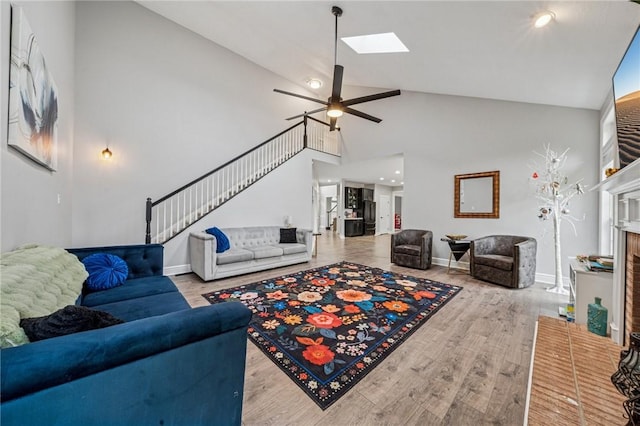 8426 David Dr, South Fayette, PA 15017 - living area featuring high vaulted ceiling, wood finished floors, ceiling fan, baseboards, and a skylight
