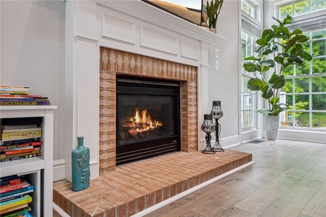 8426 David Dr, South Fayette, PA 15017 - detailed view of wood finished floors, a fireplace, and baseboards