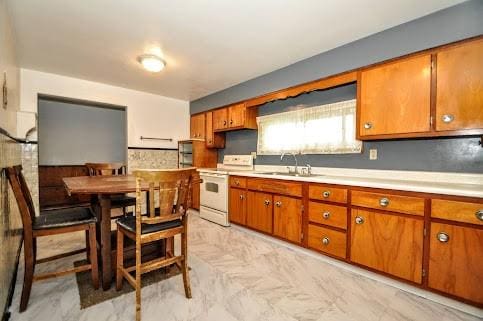 904 Mcclintock Ave, Washington Twp Fay, PA 15012 - kitchen with white electric range, a sink, brown cabinets, and light countertops