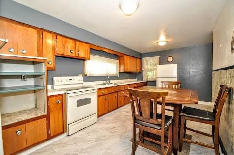 904 Mcclintock Ave, Washington Twp Fay, PA 15012 - kitchen featuring white appliances, brown cabinets, light countertops, and a sink