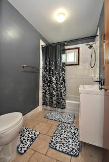 904 Mcclintock Ave, Washington Twp Fay, PA 15012 - bathroom with vanity, toilet, tile patterned floors, and shower / bathtub combination with curtain