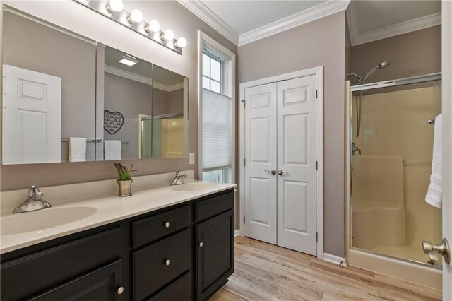 230 Patriot Ln, Economy, PA 15042 - bathroom featuring a stall shower, wood finished floors, double vanity, and ornamental molding