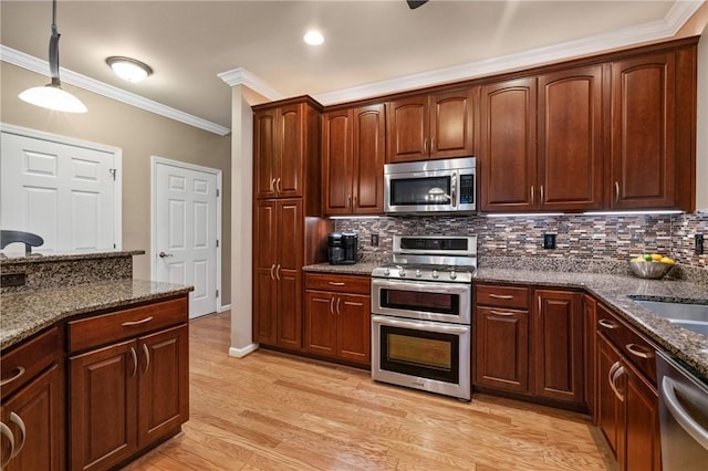 230 Patriot Ln, Economy, PA 15042 - kitchen with appliances with stainless steel finishes, crown molding, decorative backsplash, hanging light fixtures, and dark stone counters