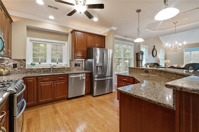 230 Patriot Ln, Economy, PA 15042 - kitchen featuring appliances with stainless steel finishes, a sink, light wood finished floors, healthy amount of natural light, and crown molding