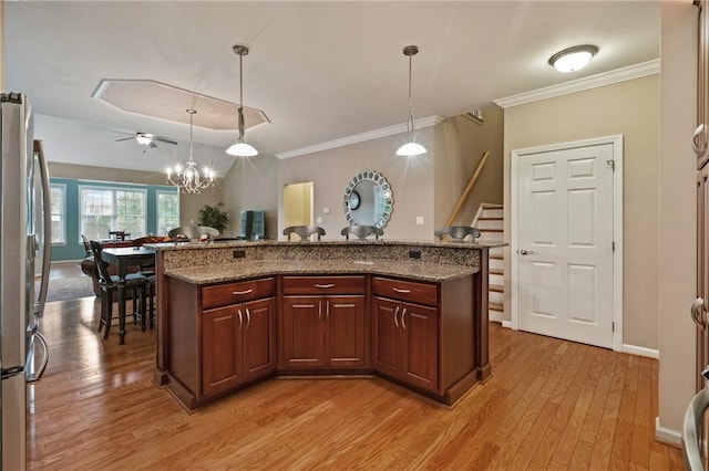 230 Patriot Ln, Economy, PA 15042 - kitchen with freestanding refrigerator, light wood finished floors, decorative light fixtures, ornamental molding, and stone counters