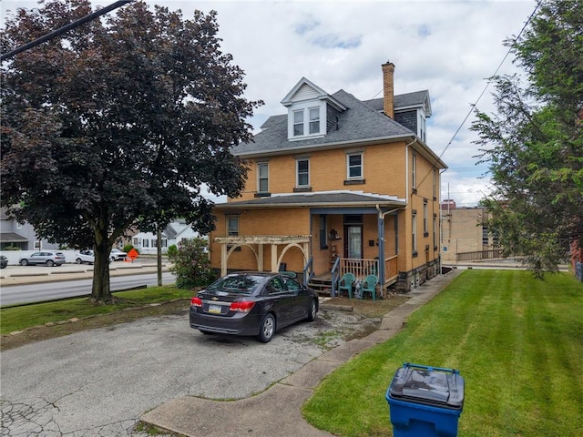 201 Thompson St, Latrobe, PA 15650 - american foursquare style home with a chimney, a front yard, and a shingled roof