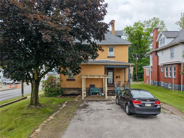 201 Thompson St, Latrobe, PA 15650 - view of front facade featuring a front lawn, brick siding, and a chimney