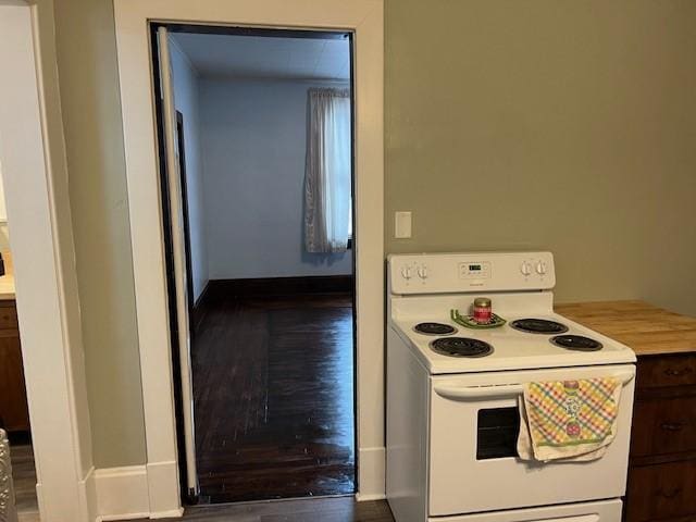 201 Thompson St, Latrobe, PA 15650 - kitchen with white range with electric cooktop, wood finished floors, baseboards, and light countertops