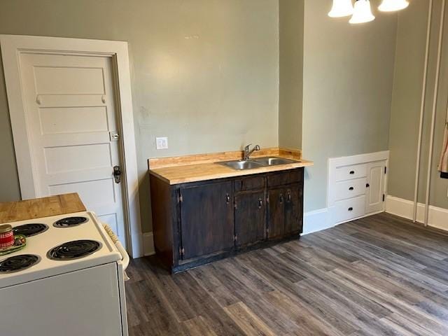 201 Thompson St, Latrobe, PA 15650 - kitchen with white electric range oven, a sink, dark wood-style flooring, light countertops, and dark brown cabinets