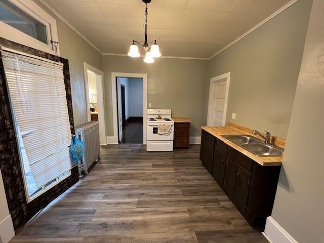 201 Thompson St, Latrobe, PA 15650 - kitchen featuring white range with electric stovetop, radiator heating unit, a sink, dark wood finished floors, and a chandelier