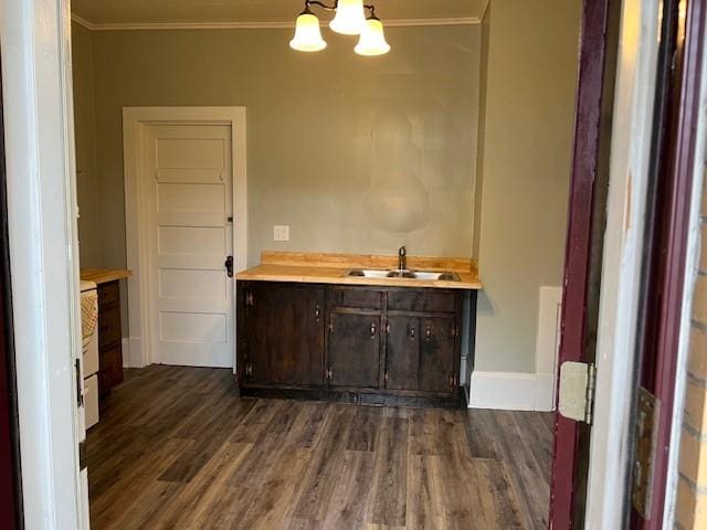 201 Thompson St, Latrobe, PA 15650 - bar area featuring a sink, ornamental molding, a chandelier, dark wood-style flooring, and baseboards