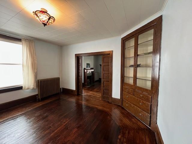 201 Thompson St, Latrobe, PA 15650 - spare room featuring radiator heating unit, wood-type flooring, and baseboards