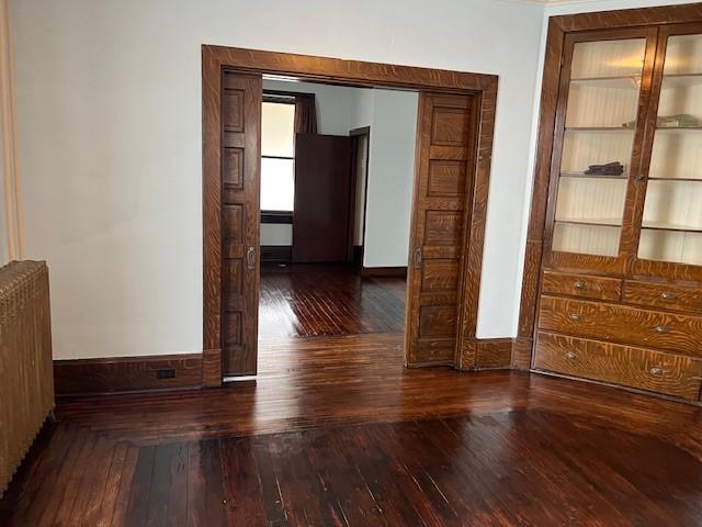 201 Thompson St, Latrobe, PA 15650 - corridor featuring radiator heating unit, wood-type flooring, and baseboards