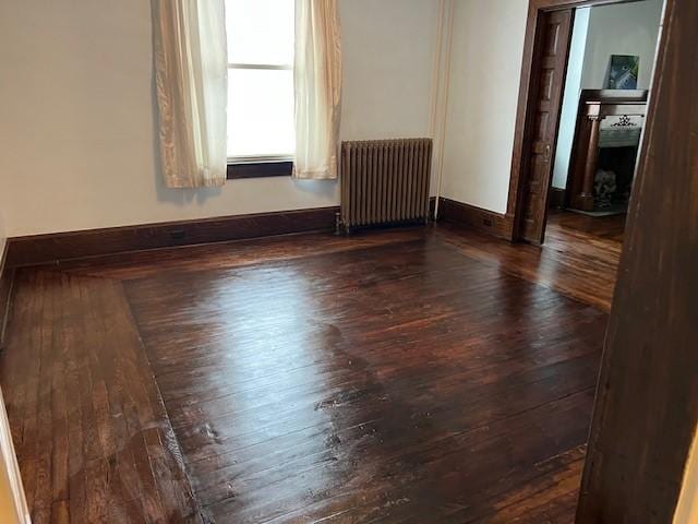 201 Thompson St, Latrobe, PA 15650 - empty room with radiator heating unit, wood-type flooring, and baseboards