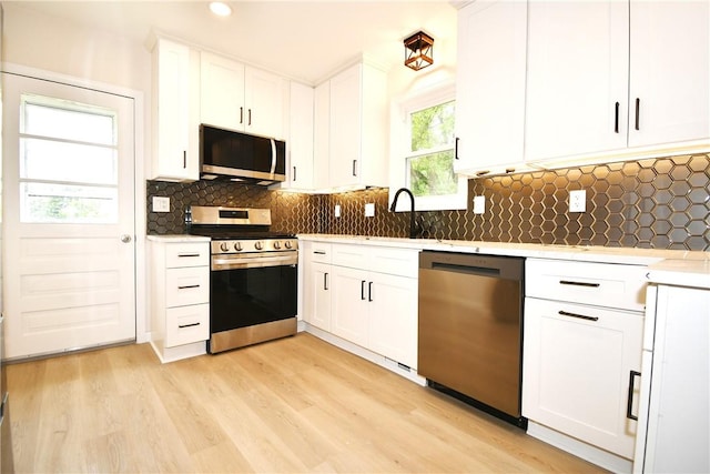 4 Brentwood Dr, Kennedy Twp, PA 15136 - kitchen featuring appliances with stainless steel finishes, a sink, light wood-type flooring, white cabinets, and light countertops