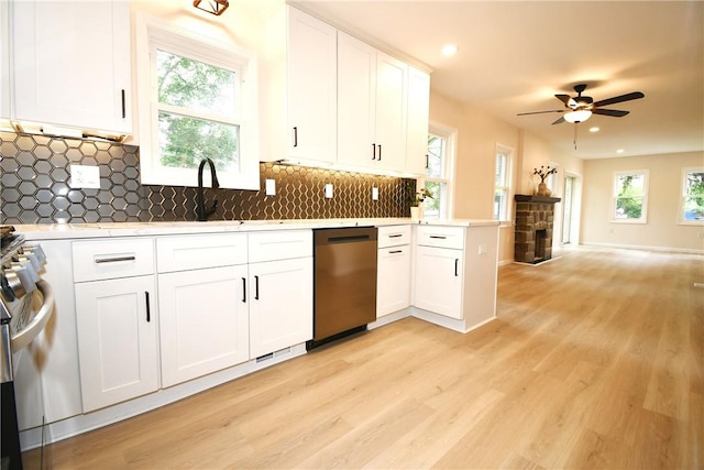 4 Brentwood Dr, Kennedy Twp, PA 15136 - kitchen featuring appliances with stainless steel finishes, light countertops, light wood-style floors, a sink, and a ceiling fan