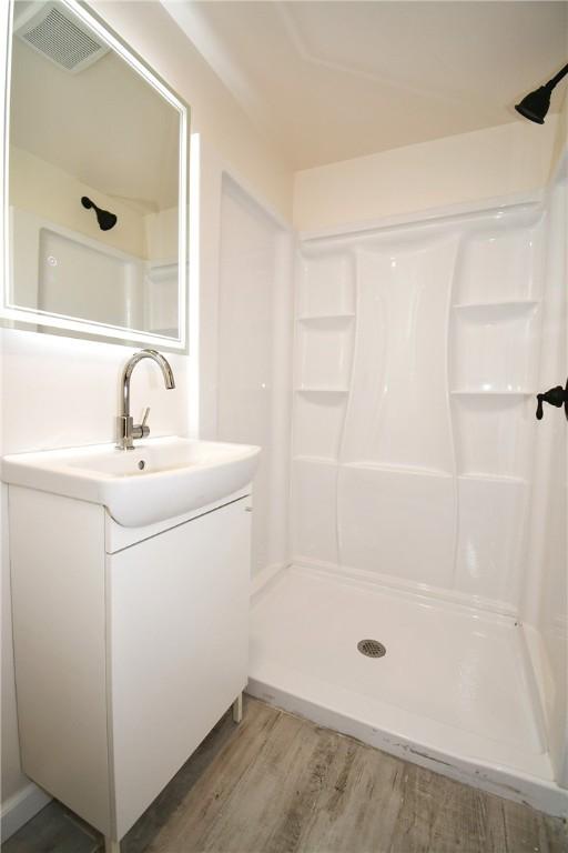 4 Brentwood Dr, Kennedy Twp, PA 15136 - bathroom with vanity, a shower, and wood finished floors