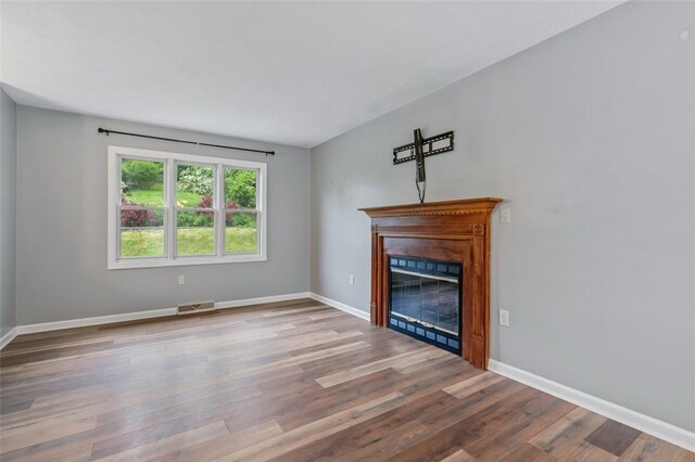 916 Timberland Ave, Brookline, PA 15226 - unfurnished living room featuring a glass covered fireplace, wood finished floors, and baseboards