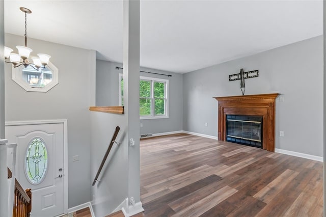 916 Timberland Ave, Brookline, PA 15226 - foyer with wood finished floors, a chandelier, a glass covered fireplace, and baseboards
