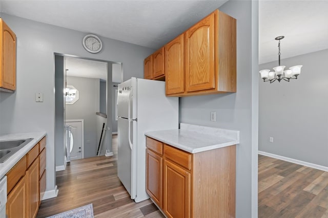 916 Timberland Ave, Brookline, PA 15226 - kitchen with a chandelier, wood finished floors, white appliances, and light countertops