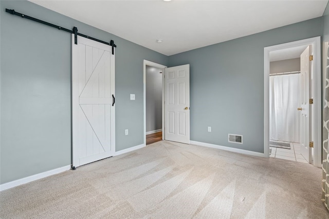 916 Timberland Ave, Brookline, PA 15226 - unfurnished bedroom featuring carpet flooring, a barn door, baseboards, and ensuite bath
