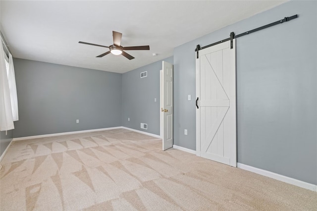 916 Timberland Ave, Brookline, PA 15226 - unfurnished bedroom featuring a barn door, light carpet, baseboards, and a ceiling fan