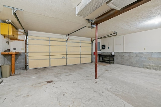 916 Timberland Ave, Brookline, PA 15226 - garage with concrete block wall, a garage door opener, and electric panel