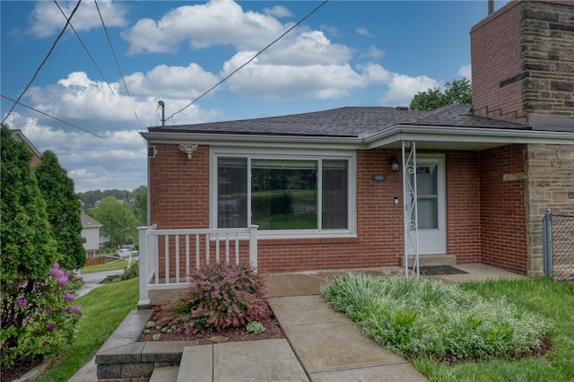 1566 Greentree Rd, Scott Twp Sal, PA 15220 - view of exterior entry featuring brick siding, a chimney, and roof with shingles