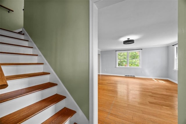 1509 Walnut St, Edgewood, PA 15218 - stairway with wood finished floors, baseboards, and ornamental molding