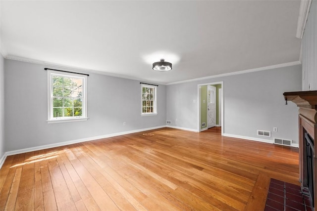 1509 Walnut St, Edgewood, PA 15218 - unfurnished living room featuring a fireplace with flush hearth, light wood-type flooring, baseboards, healthy amount of natural light, and crown molding