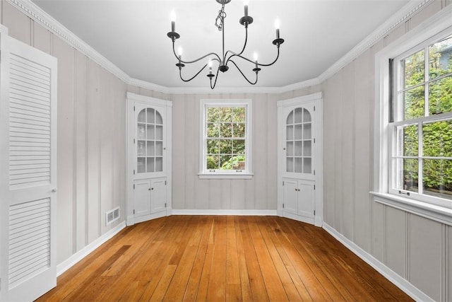 1509 Walnut St, Edgewood, PA 15218 - unfurnished dining area with a chandelier, light wood-style flooring, ornamental molding, and baseboards