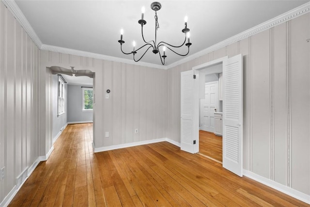 1509 Walnut St, Edgewood, PA 15218 - unfurnished dining area featuring a chandelier, crown molding, light wood-style flooring, and baseboards