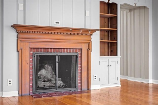 1509 Walnut St, Edgewood, PA 15218 - detailed view of wood finished floors, baseboards, and a fireplace