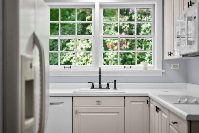 1509 Walnut St, Edgewood, PA 15218 - kitchen featuring white appliances, a sink, white cabinetry, and light countertops