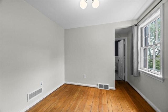 1509 Walnut St, Edgewood, PA 15218 - spare room with plenty of natural light, wood-type flooring, and baseboards
